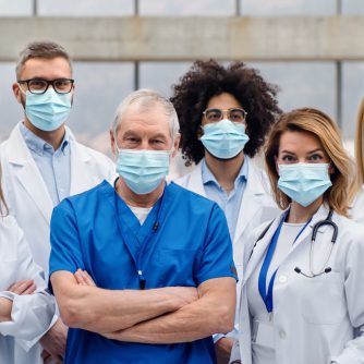 group of doctors with face masks looking at camera